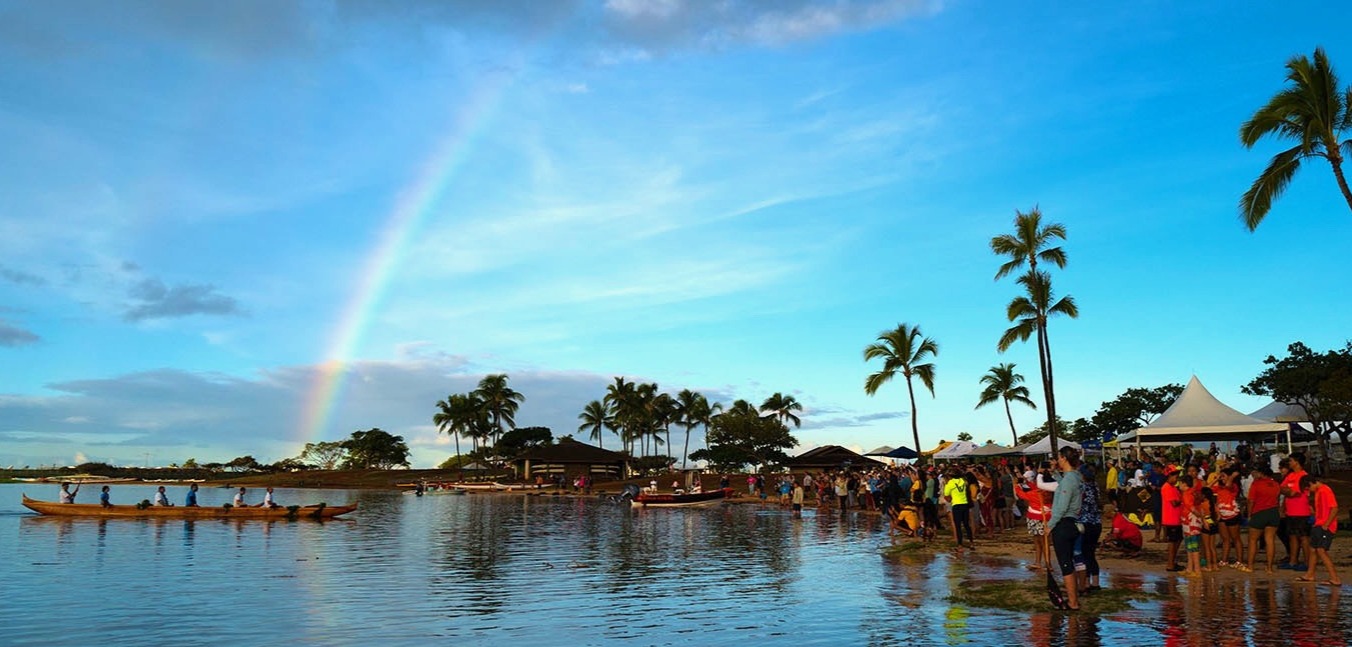 Canoe ceremony with rainbow