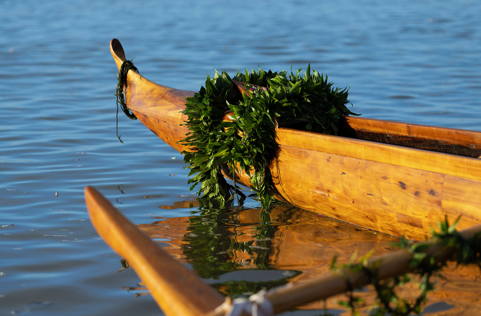 Canoe prow adorned with greenery